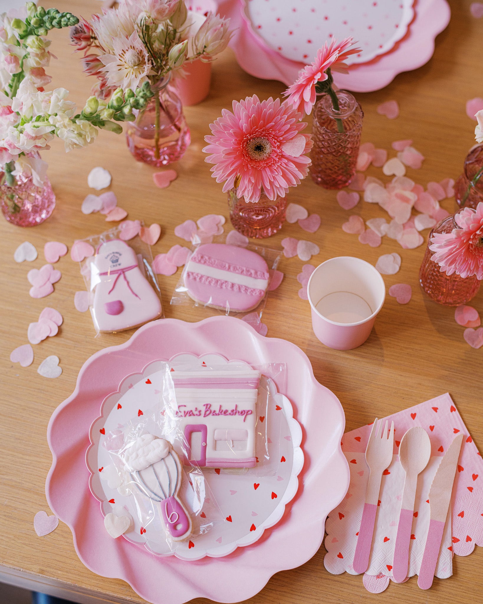Close-up of small vase with soft pink seasonal flowers – fresh and romantic table arrangement