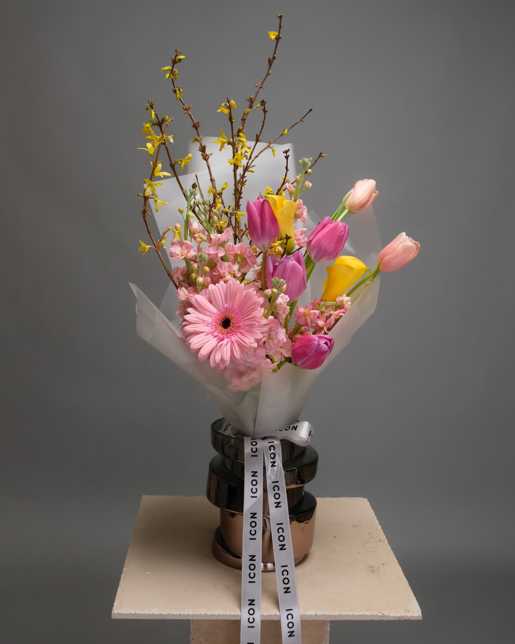 Modern bouquet with assorted seasonal flowers in varied shapes and colors standing in a vase