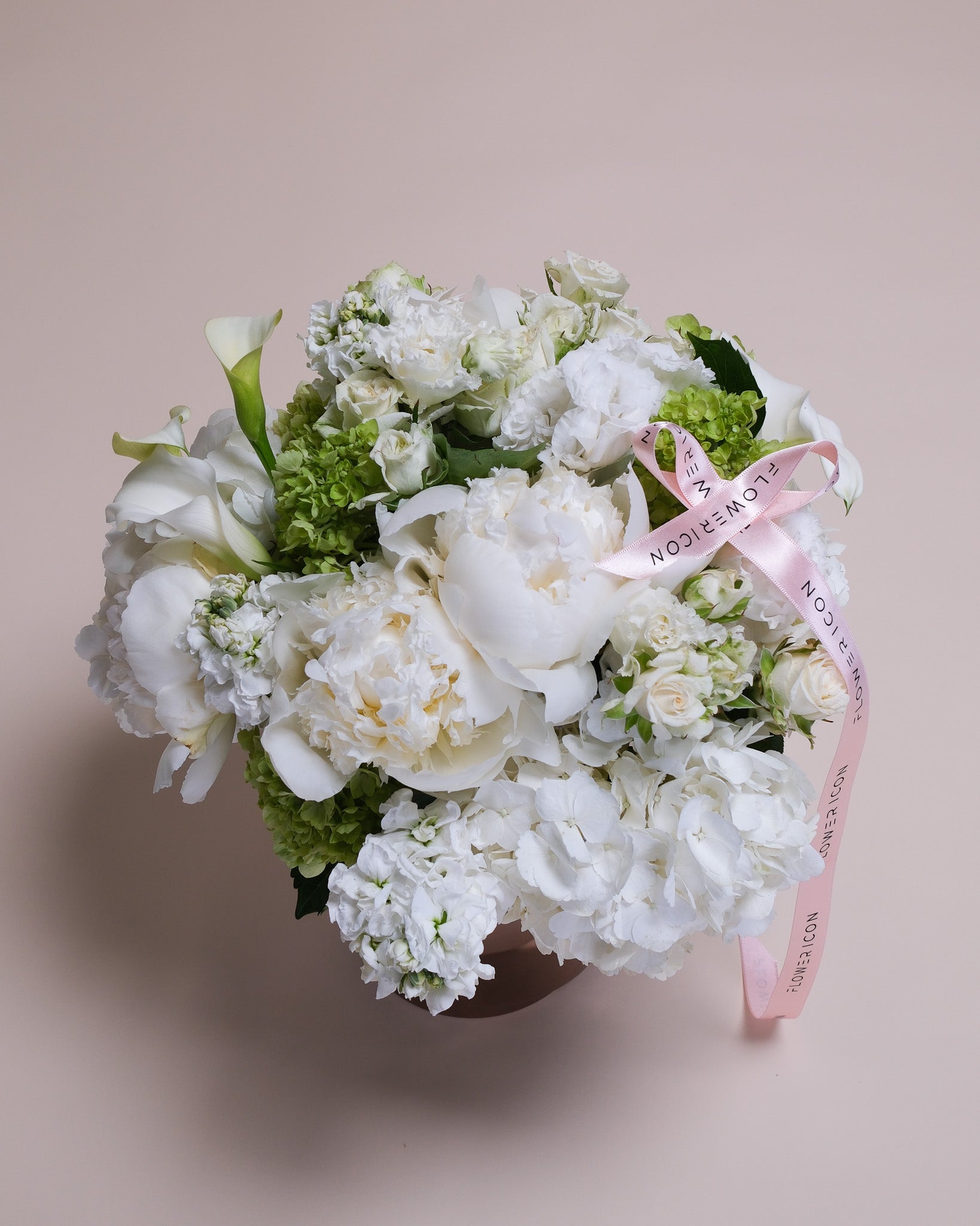 White floral bouquet in a vase, showcasing the layered beauty of peonies, hydrangeas, and calla lilies in a modern, upscale presentation.