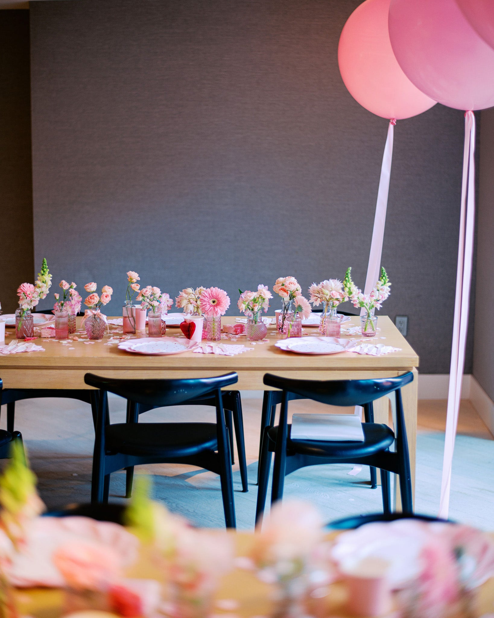 Overhead view of delicate pink-toned floral vases with local seasonal blooms – perfect for event or dinner table décor