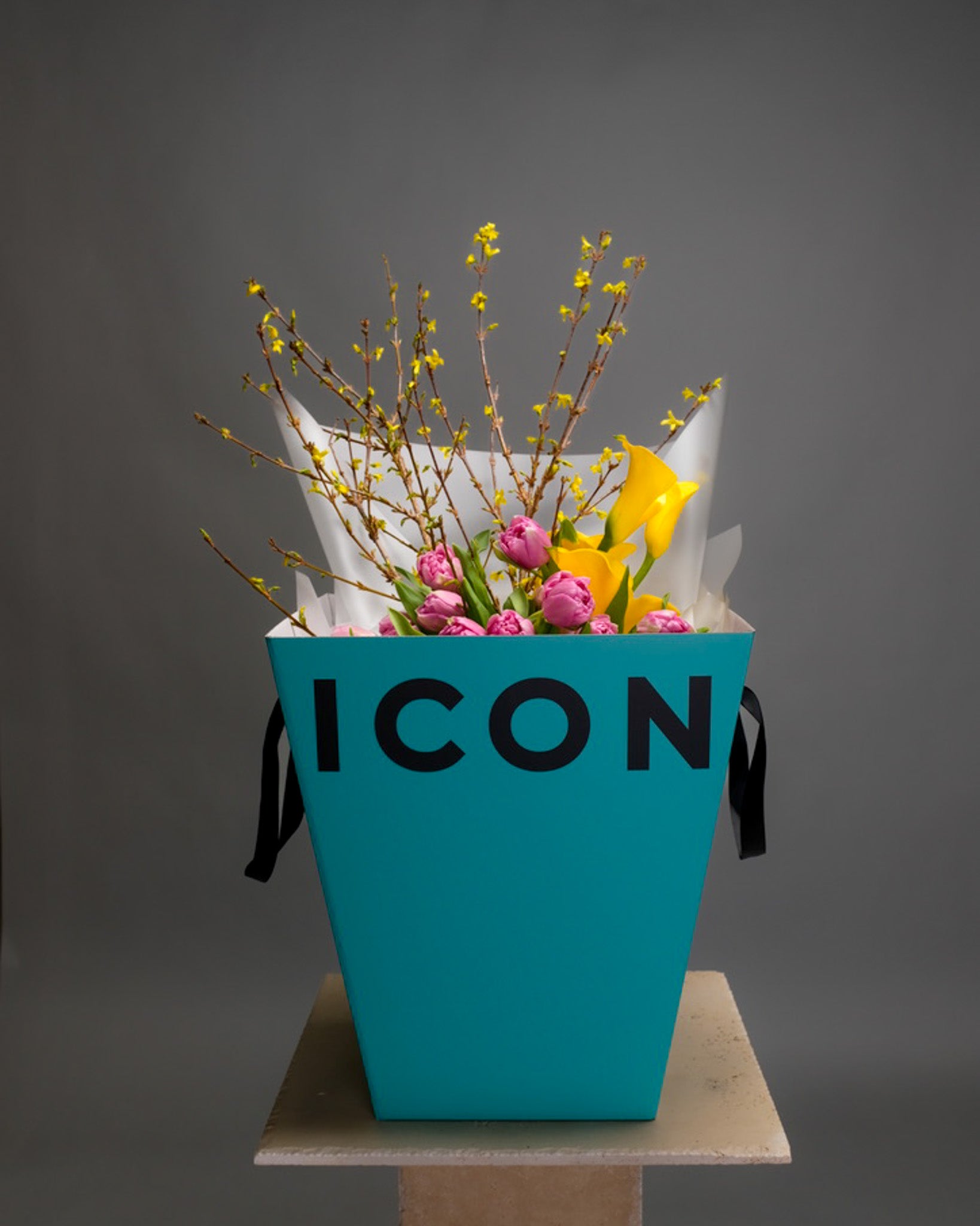 Spring bouquet in Flower Icon’s signature box with yellow and purple blooms – cheerful and elegant flower gift
