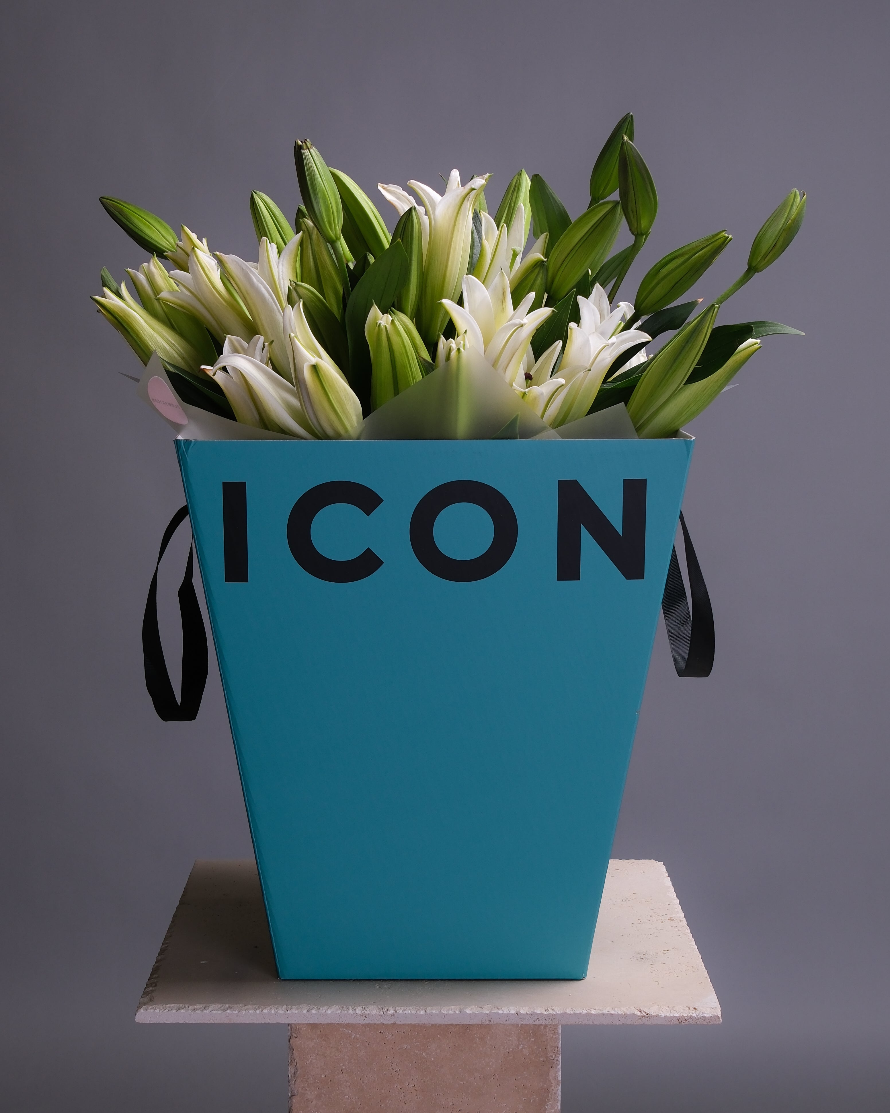 Large mono bouquet of white lilies arranged in a signature gift box, showcasing their graceful blooms and refined, elegant presentation.
