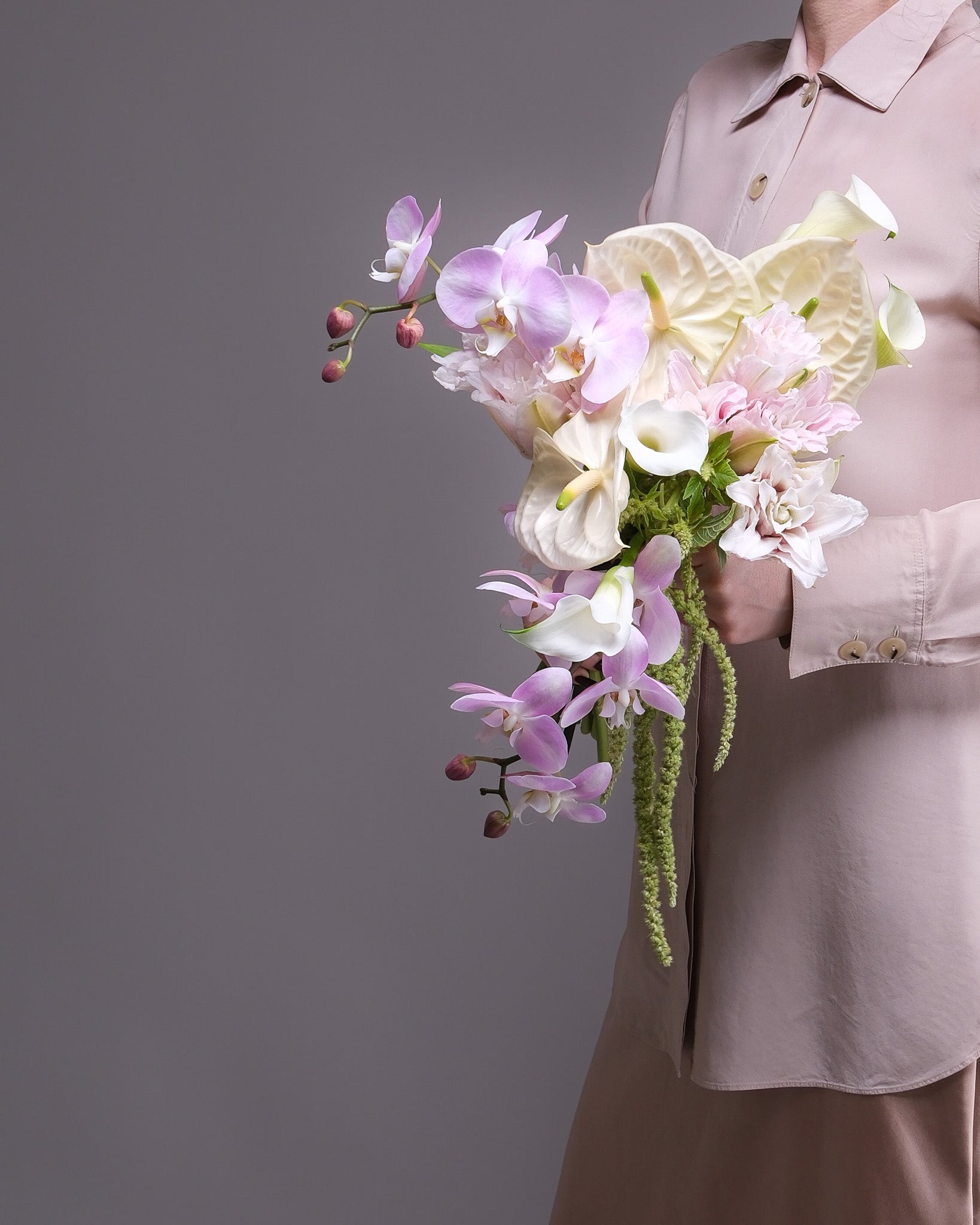 Cascading bridal bouquet of blush phalaenopsis orchids, white anthuriums and calla lilies — Flower Icon SF florist