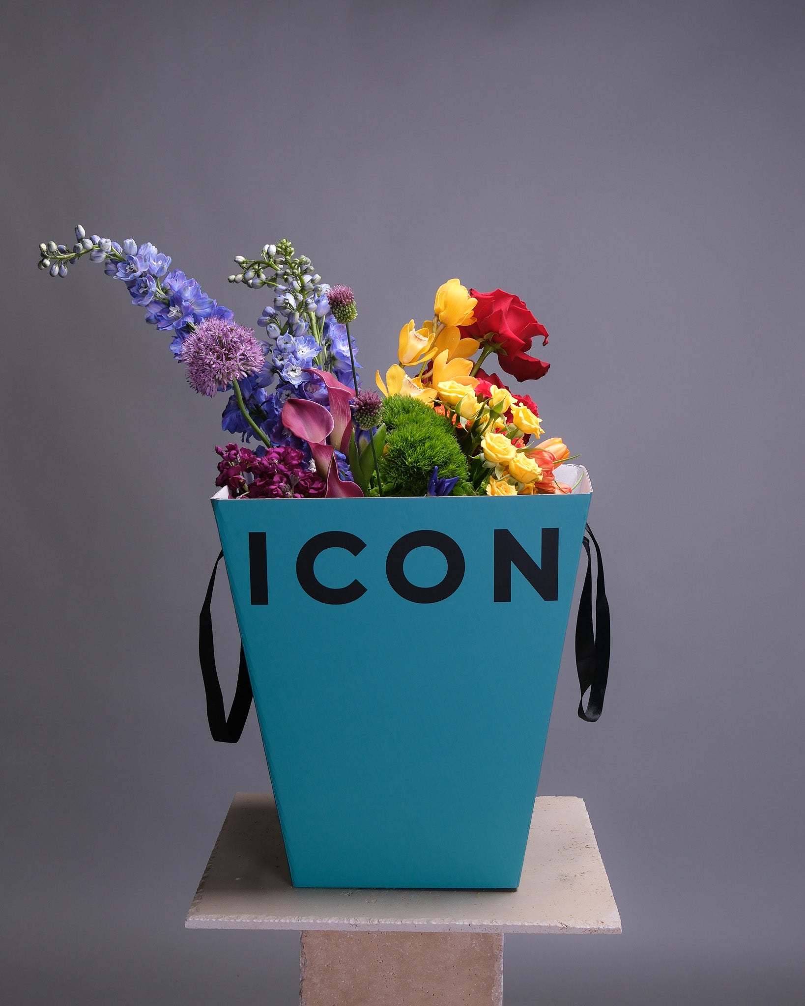 Pride bouquet displayed in a box, featuring an extravagant mix of flowers in bold rainbow colors for a celebratory statement.