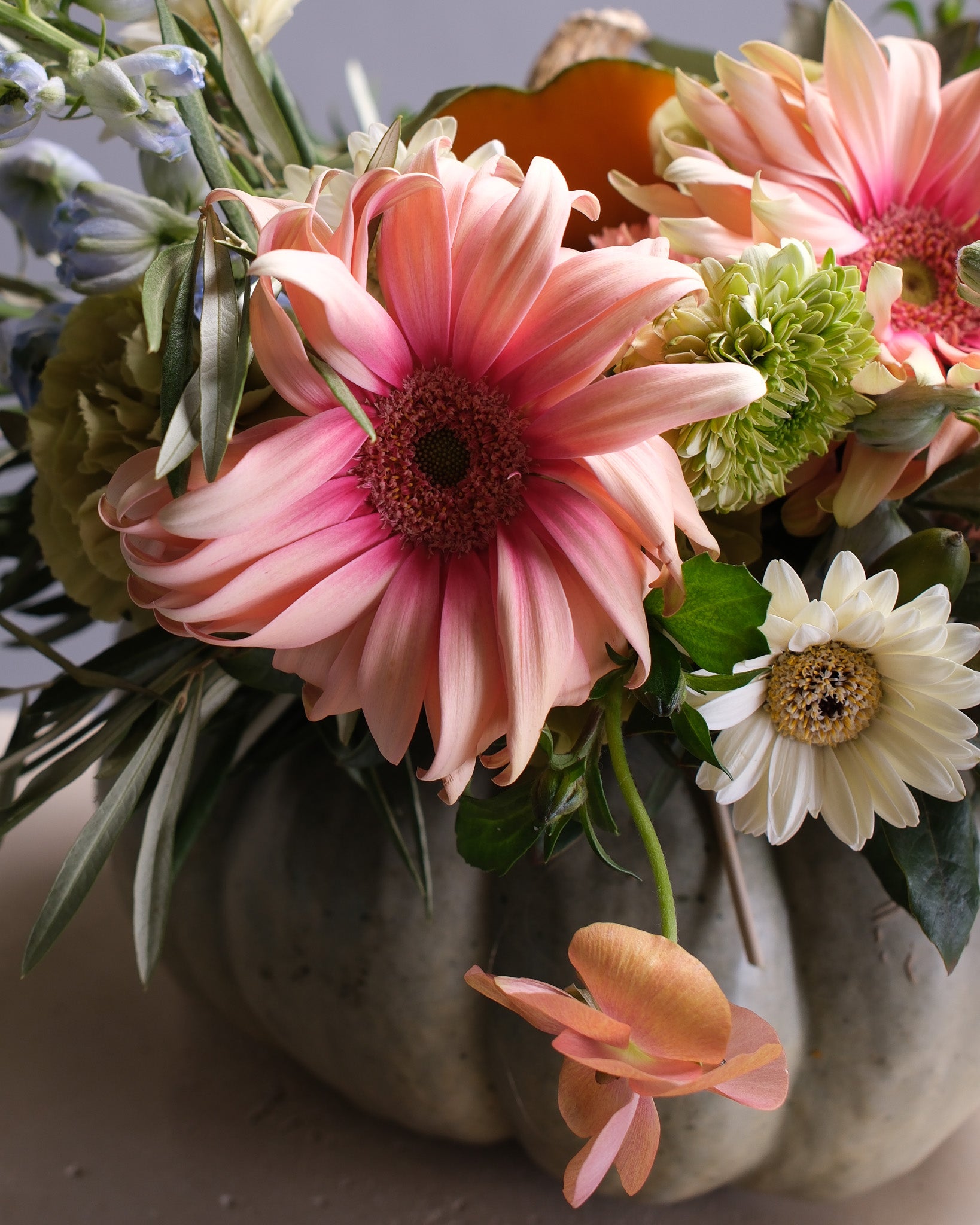 Bouquet of pink, green, and white flowers in a pumpkin by Flower Icon