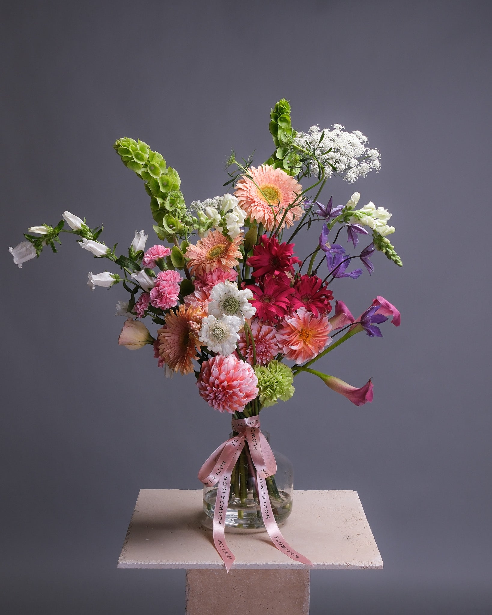 Large vibrant summer bouquet with dahlias, Gerbera daisies, scabiosas, carnations, calla lilies, clematis, and mixed seasonal blooms