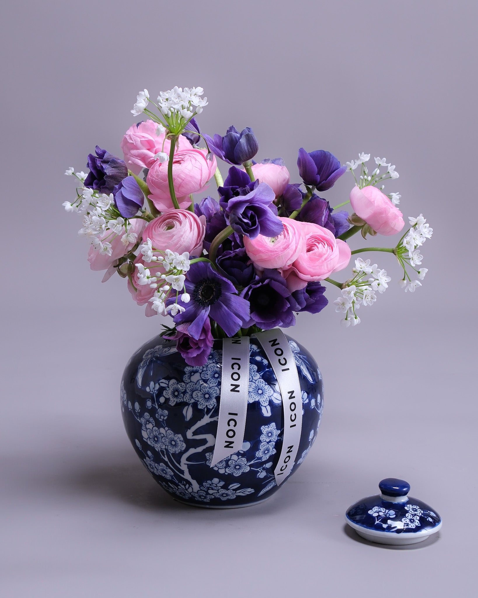 Decorative vase with floral arrangement on a gray background
