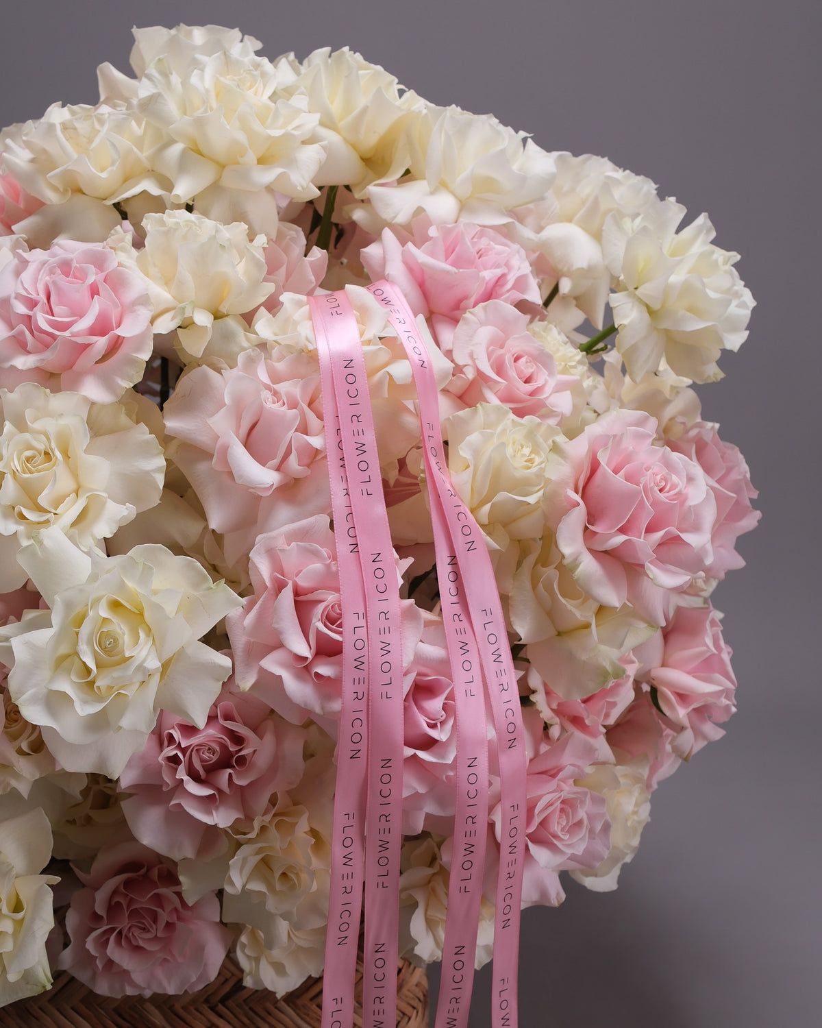 Pink satin Flower Icon ribbon over ruffled blush and white roses