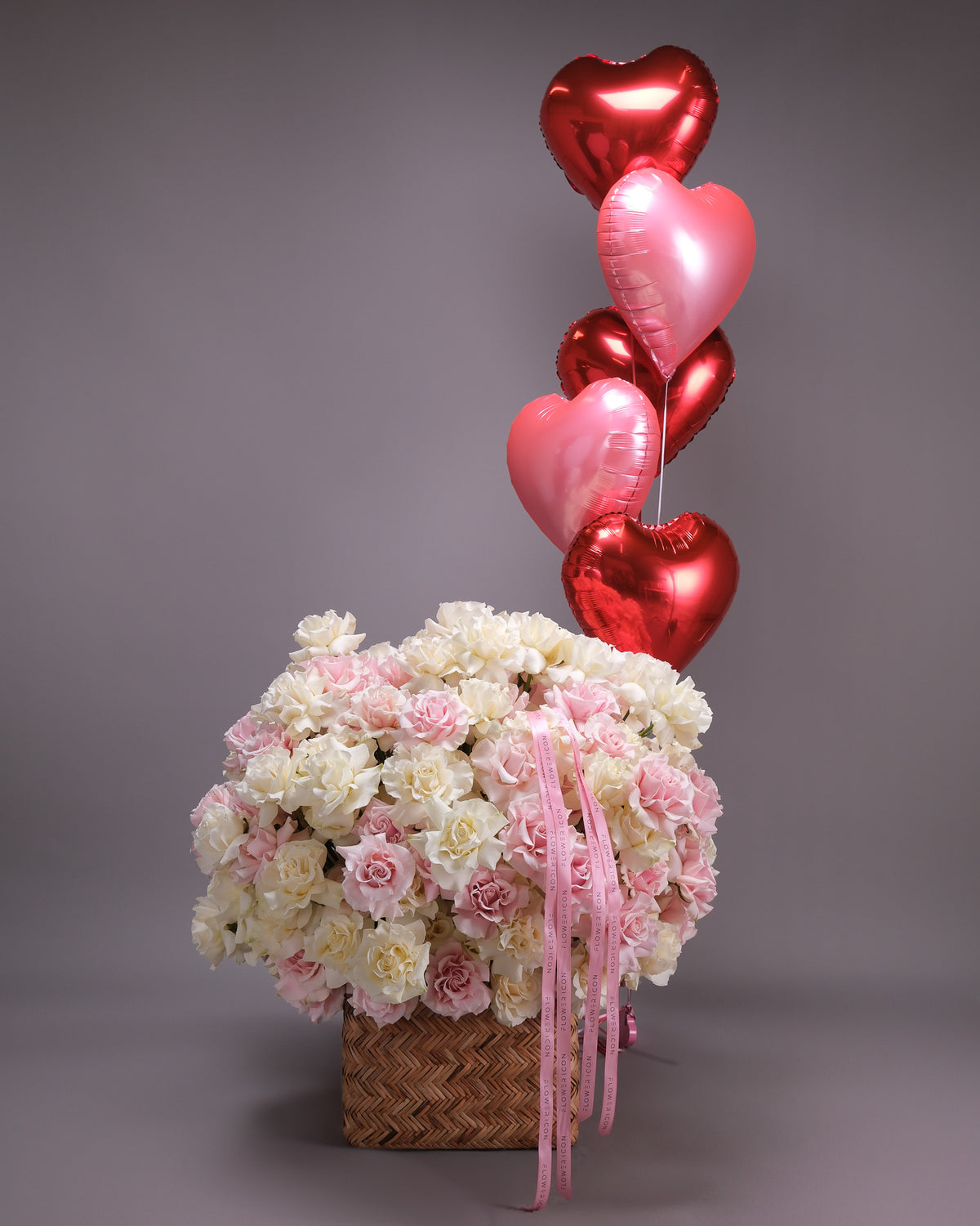 Pink and white roses basket with red and pink heart balloon bouquet add-on